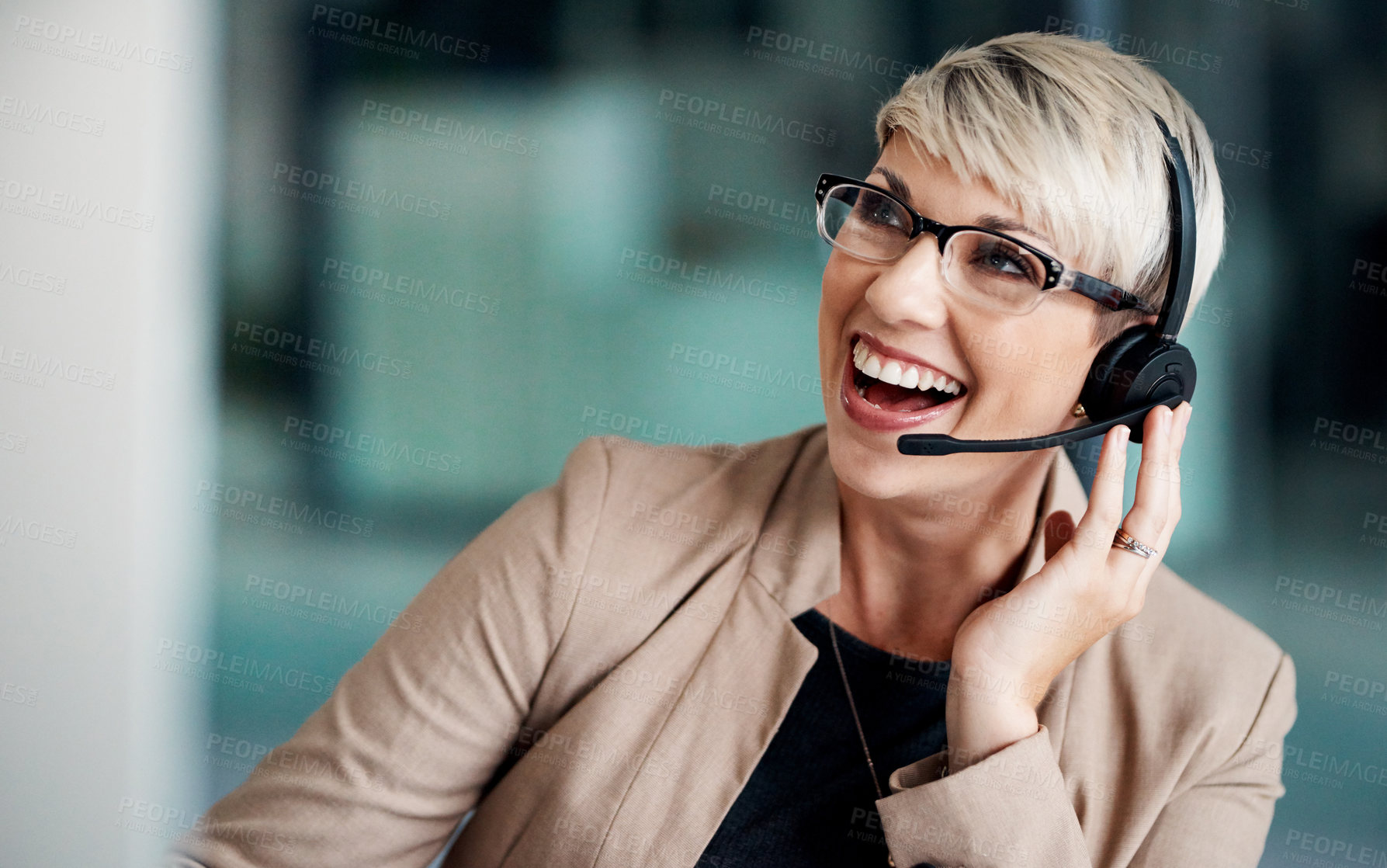 Buy stock photo Shot of a young businesswoman wearing a headset while working on a computer in an office