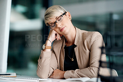 Buy stock photo Shot of a young businesswoman sleeping at a desk in an office