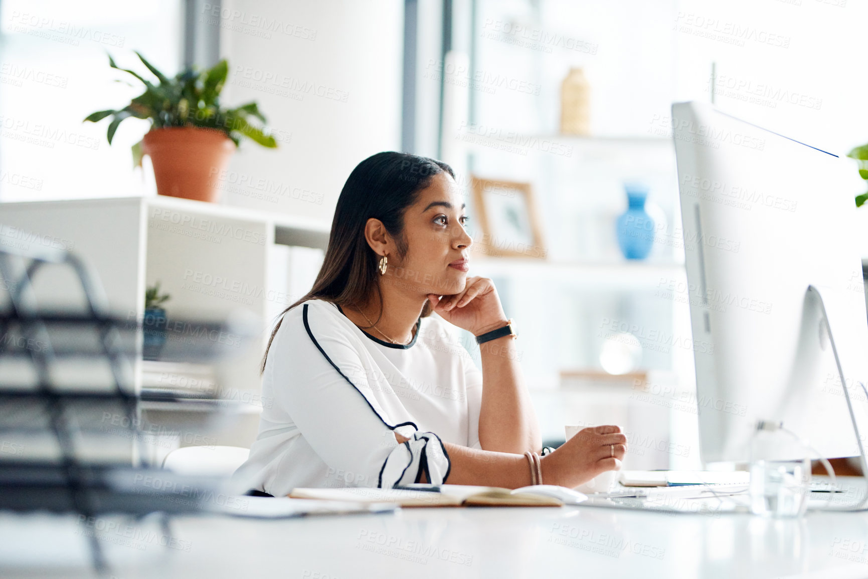 Buy stock photo Shot of a young businesswoman working on a computer in an office