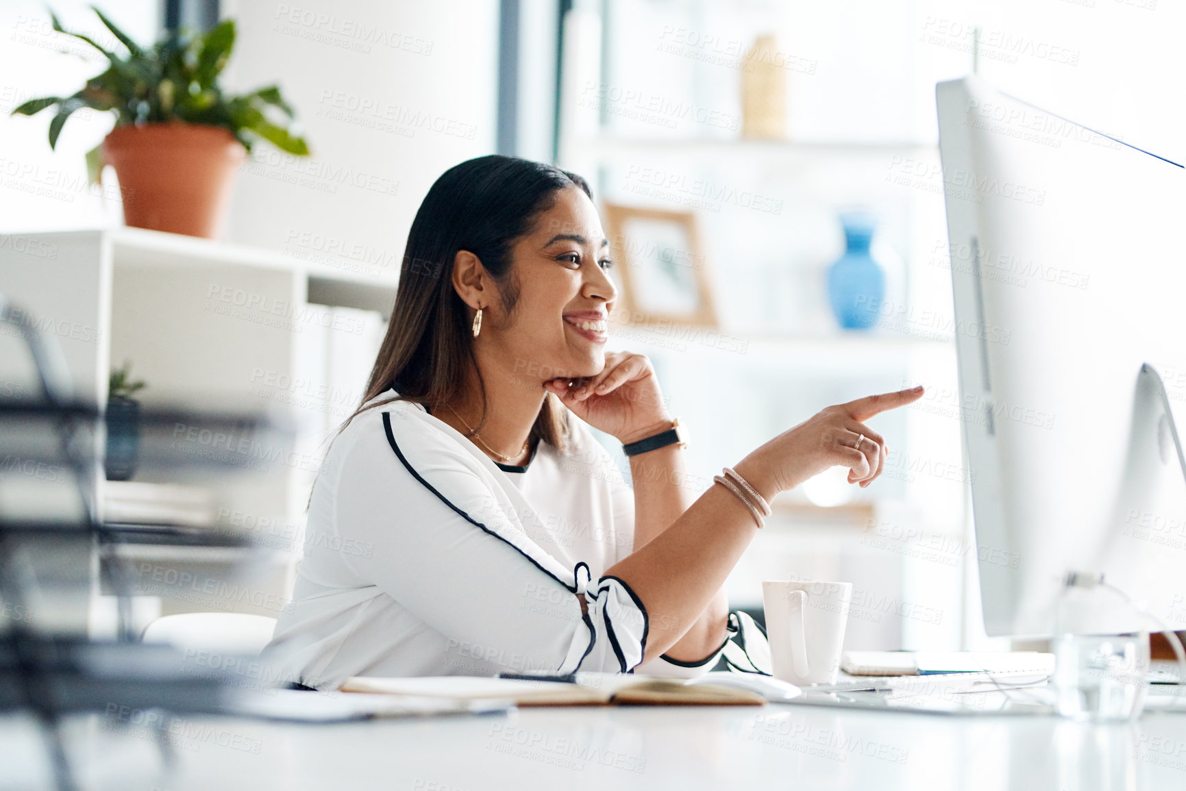 Buy stock photo Shot of a young businesswoman working on a computer in an office