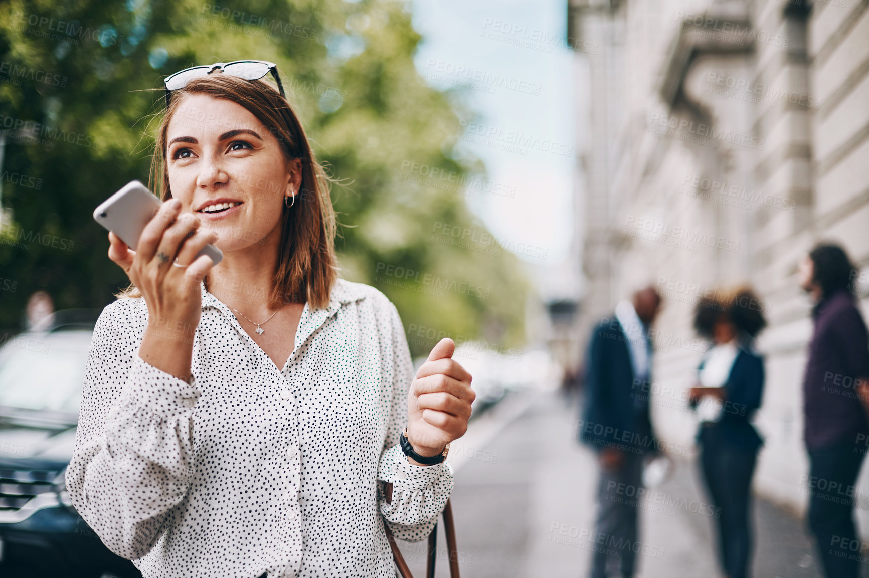 Buy stock photo Shot of a businesswoman using her cellphone while out in the city