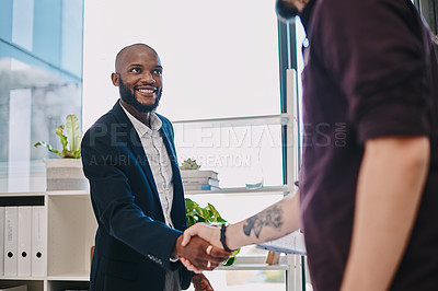 Buy stock photo Shot of two businesspeople shaking hands at the office