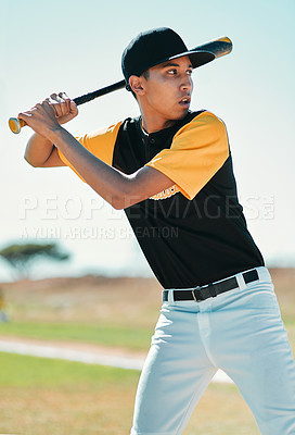 Buy stock photo Shot of a baseball player swinging his bat while out on the pitch