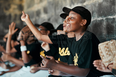 Buy stock photo Cropped shot of a group of young baseball players cheering and supporting their team from the bench during a game