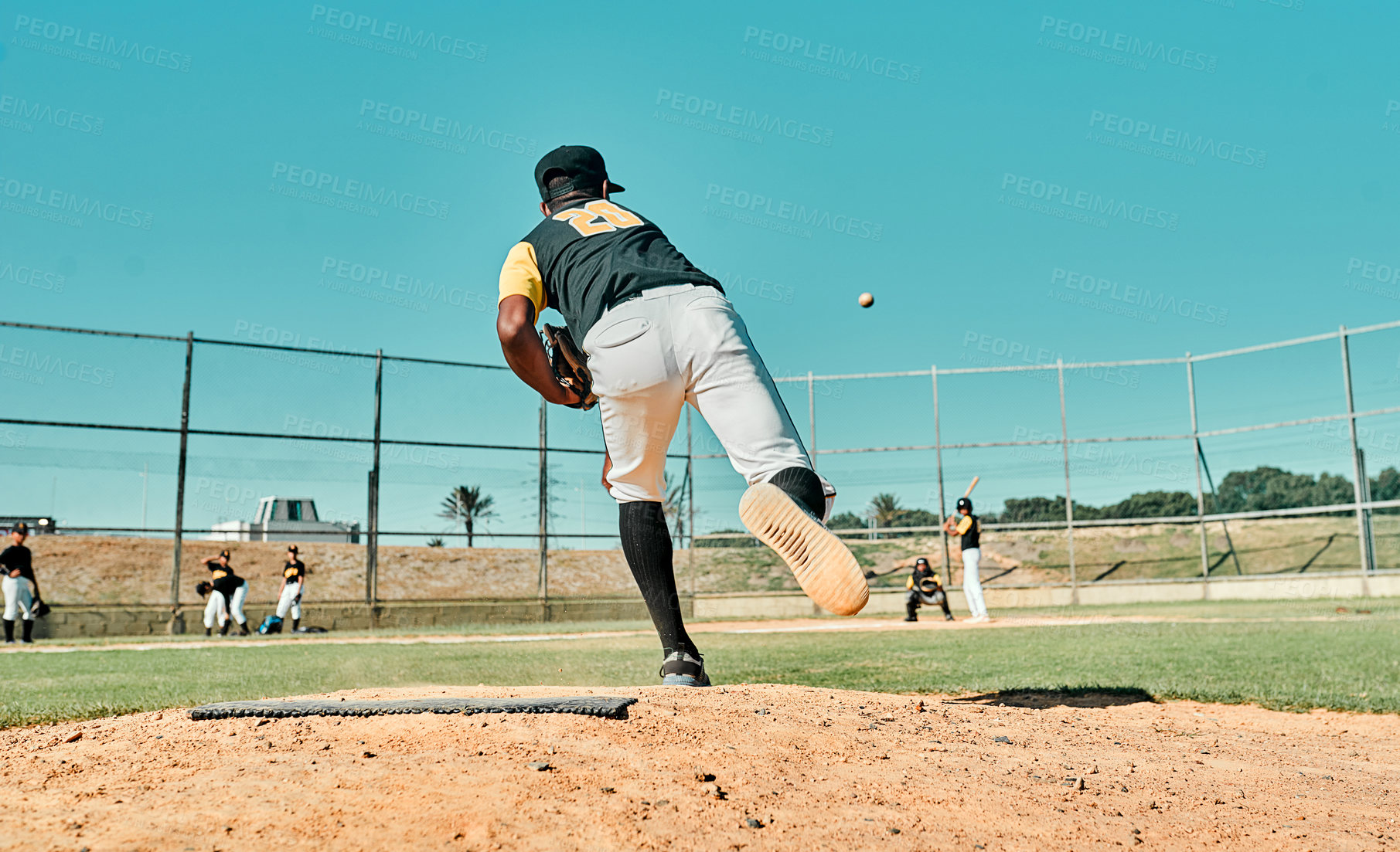 Buy stock photo Shot of a young baseball player pitching the ball during a game outdoors