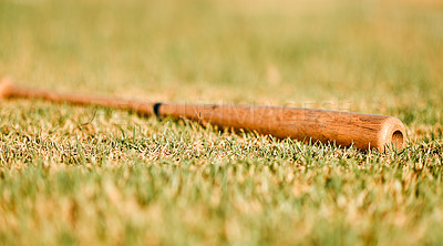 Buy stock photo Baseball, grass and bat on pitch for sports training, fitness and tournament game in outdoor stadium. Exercise, wooden object or softball equipment outside for match on professional field or ground