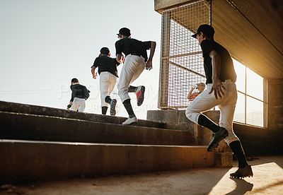 Buy stock photo Rearview shot of a team of baseball players running onto the field