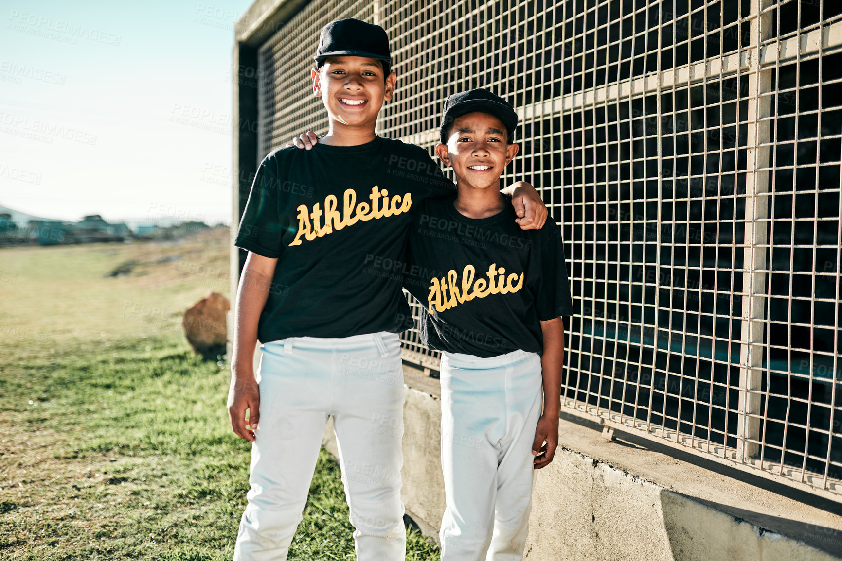 Buy stock photo Portrait of two young baseball players standing together on the pitch
