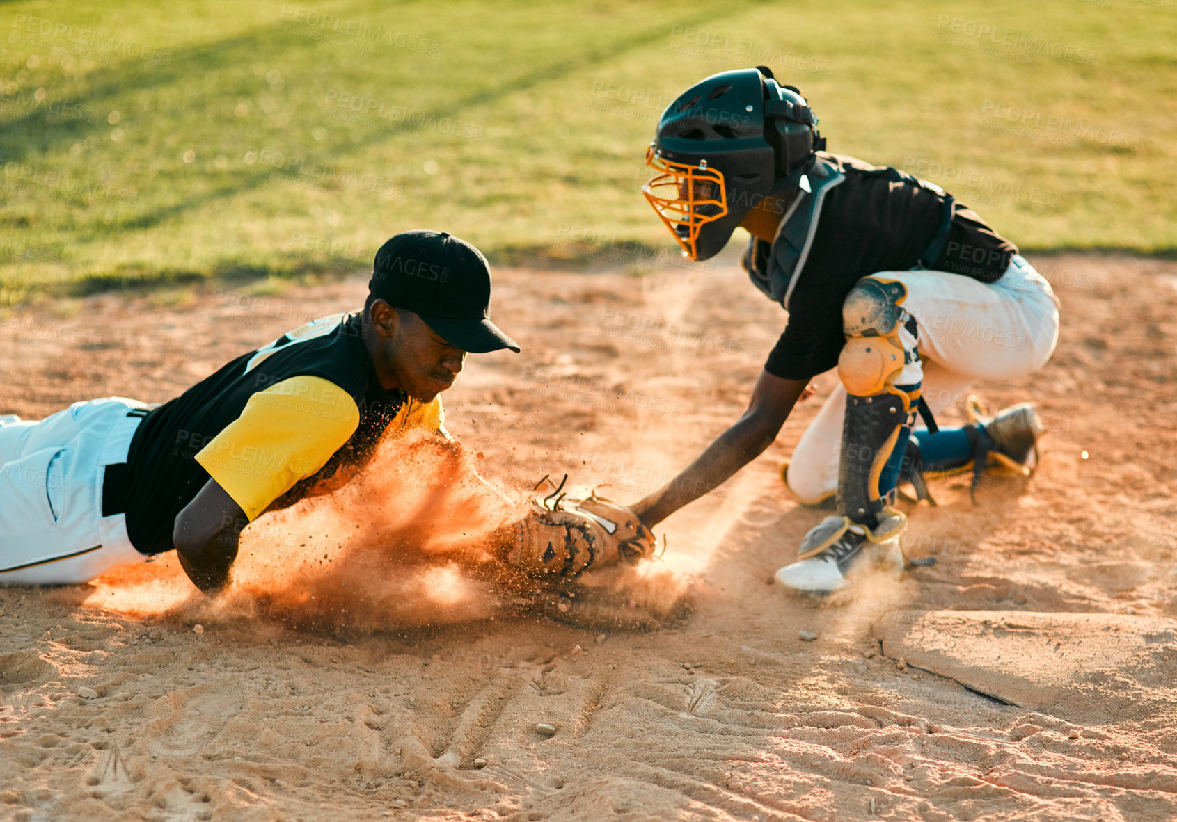 Buy stock photo Shot of a baseball player sliding to the base during a baseball game