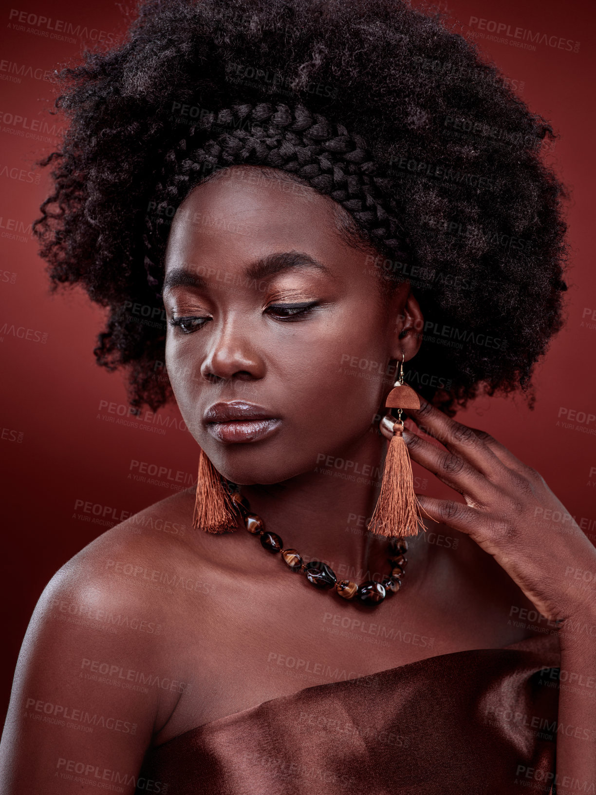 Buy stock photo Beauty, natural skin and black woman in studio with glow on gradient, maroon or red background. Face, makeup and African lady model with culture, pride or cosmetic, isolated or style and aesthetic 