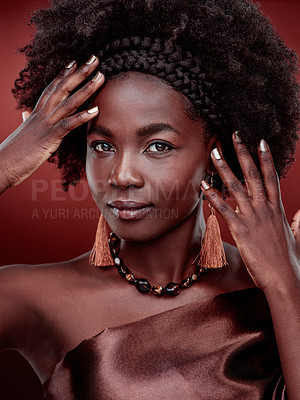 Buy stock photo Portrait, beauty and black woman with fashion in studio isolated on a red background. Natural face, makeup cosmetics and confident African model with stylish outfit, traditional headband or aesthetic