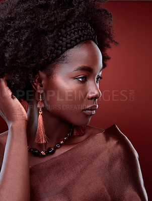 Buy stock photo Thinking, natural beauty and black woman with fashion in studio isolated on a red background. Aesthetic, makeup cosmetics and serious African model with stylish outfit, traditional jewelry or culture