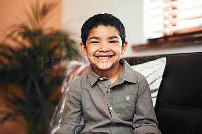 Buy stock photo Portrait of an adorable little boy relaxing on the sofa at home