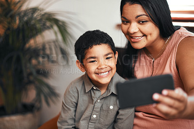 Buy stock photo Shot of a mother and her little son taking selfies together at home