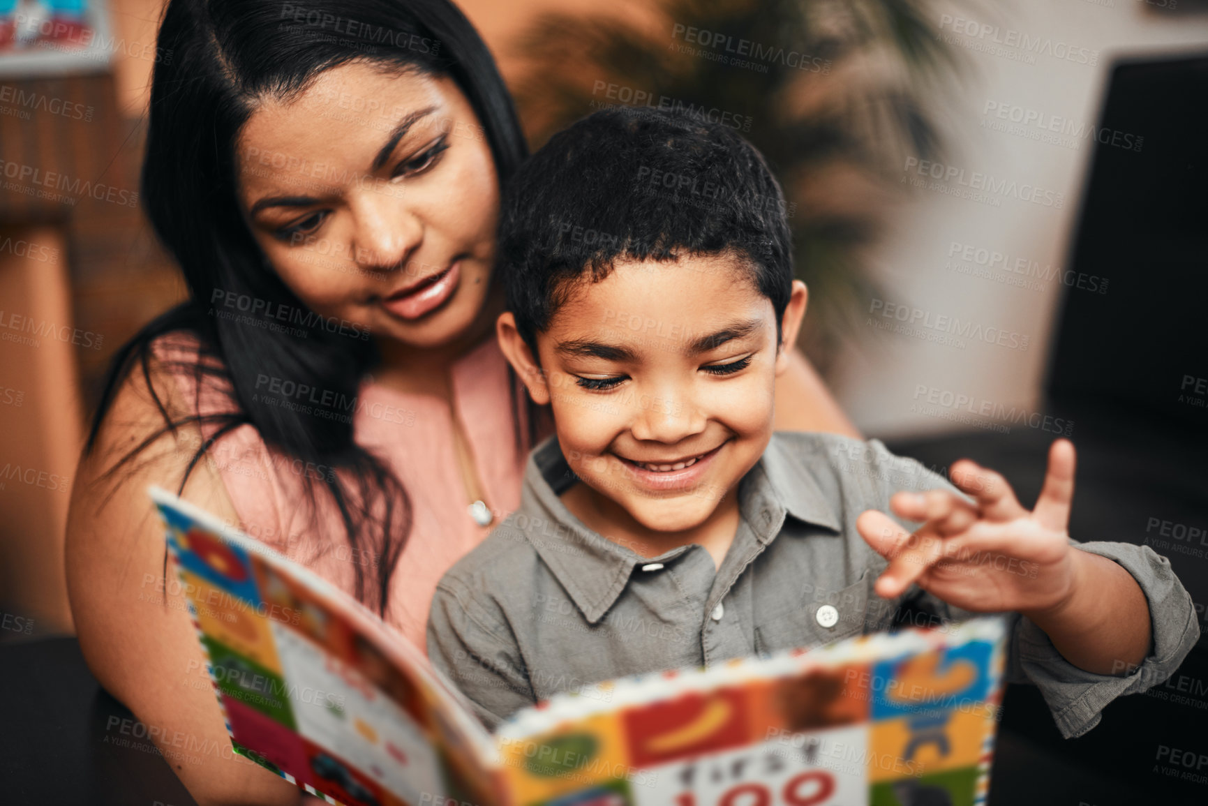 Buy stock photo Mother, son and happy with book, learning and reading together with support, care and love in family home. Woman, boy child and teaching for education, development and life skills in house with story