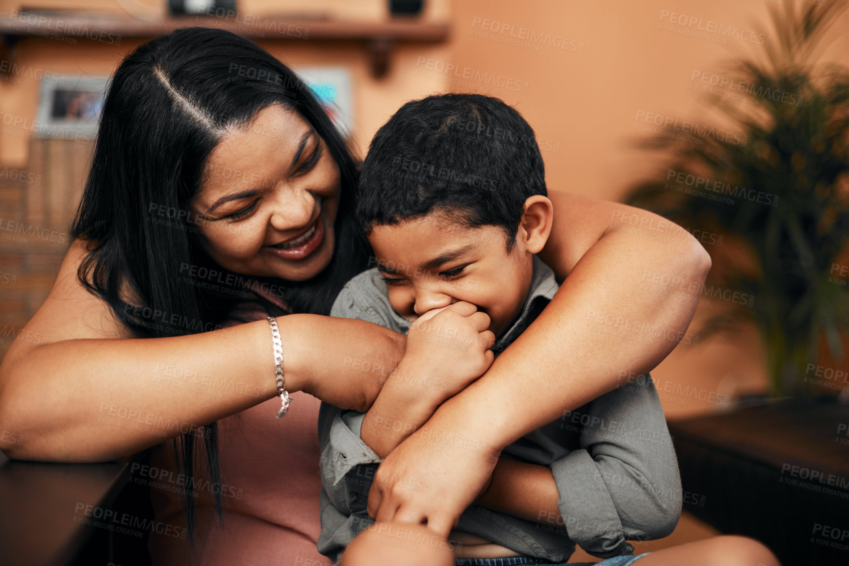 Buy stock photo Shot of a mother tickling her little son at home