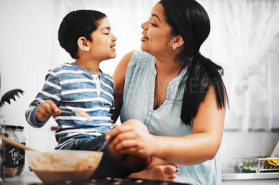 Buy stock photo Shot of a mother and her little son baking together at home