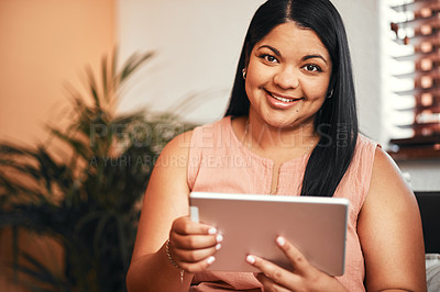 Buy stock photo Portrait of a young woman using a digital tablet at home