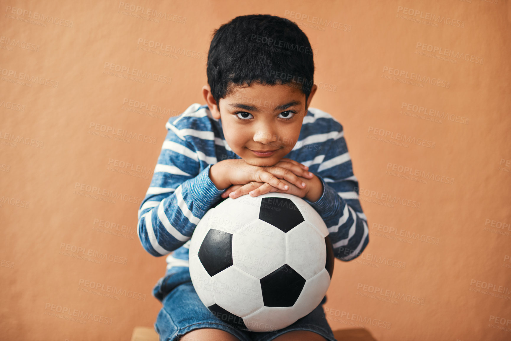 Buy stock photo Portrait of an adorable little boy posing with a soccer ball