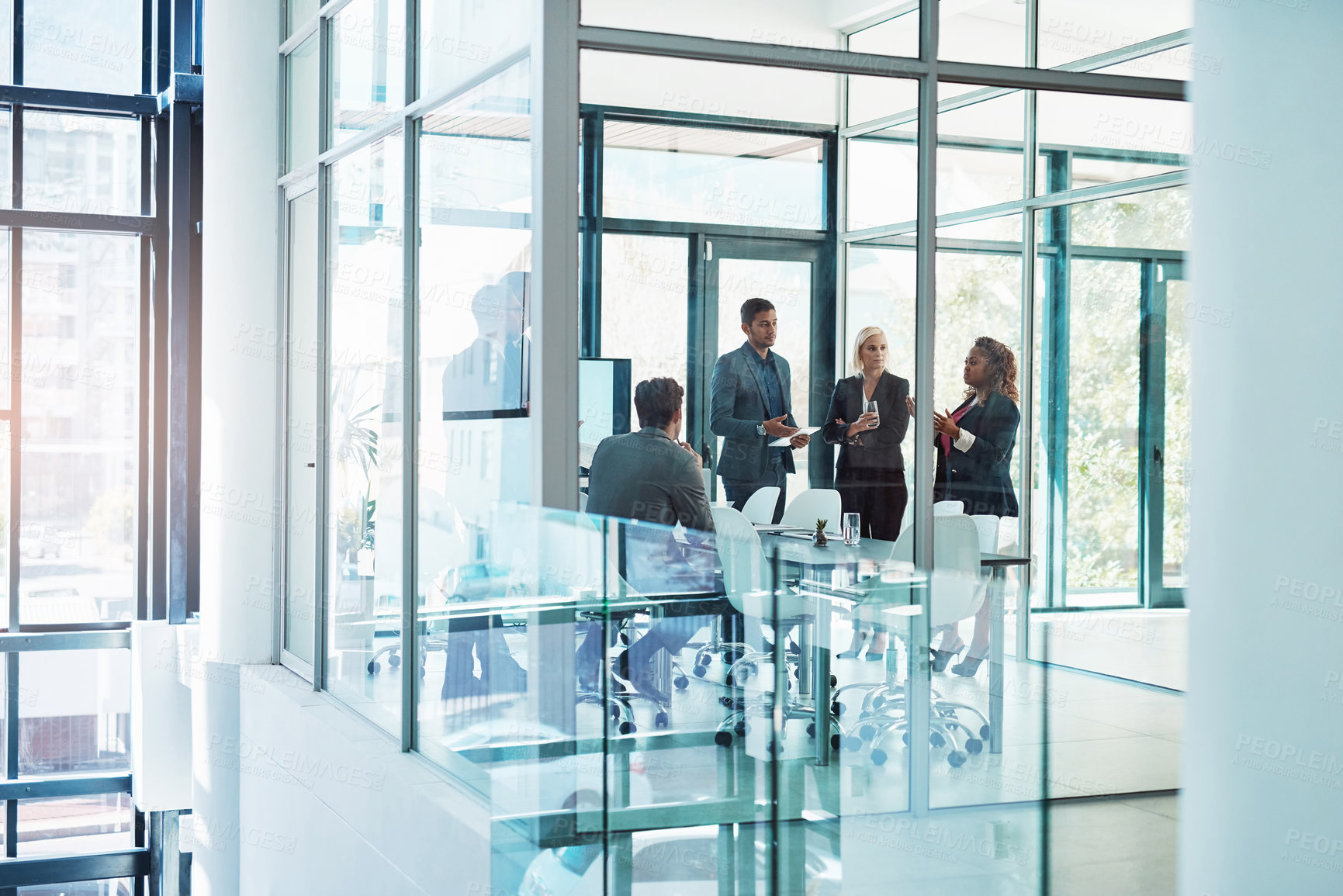 Buy stock photo Full length shot of a group of corporate businesspeople meeting in the boardroom