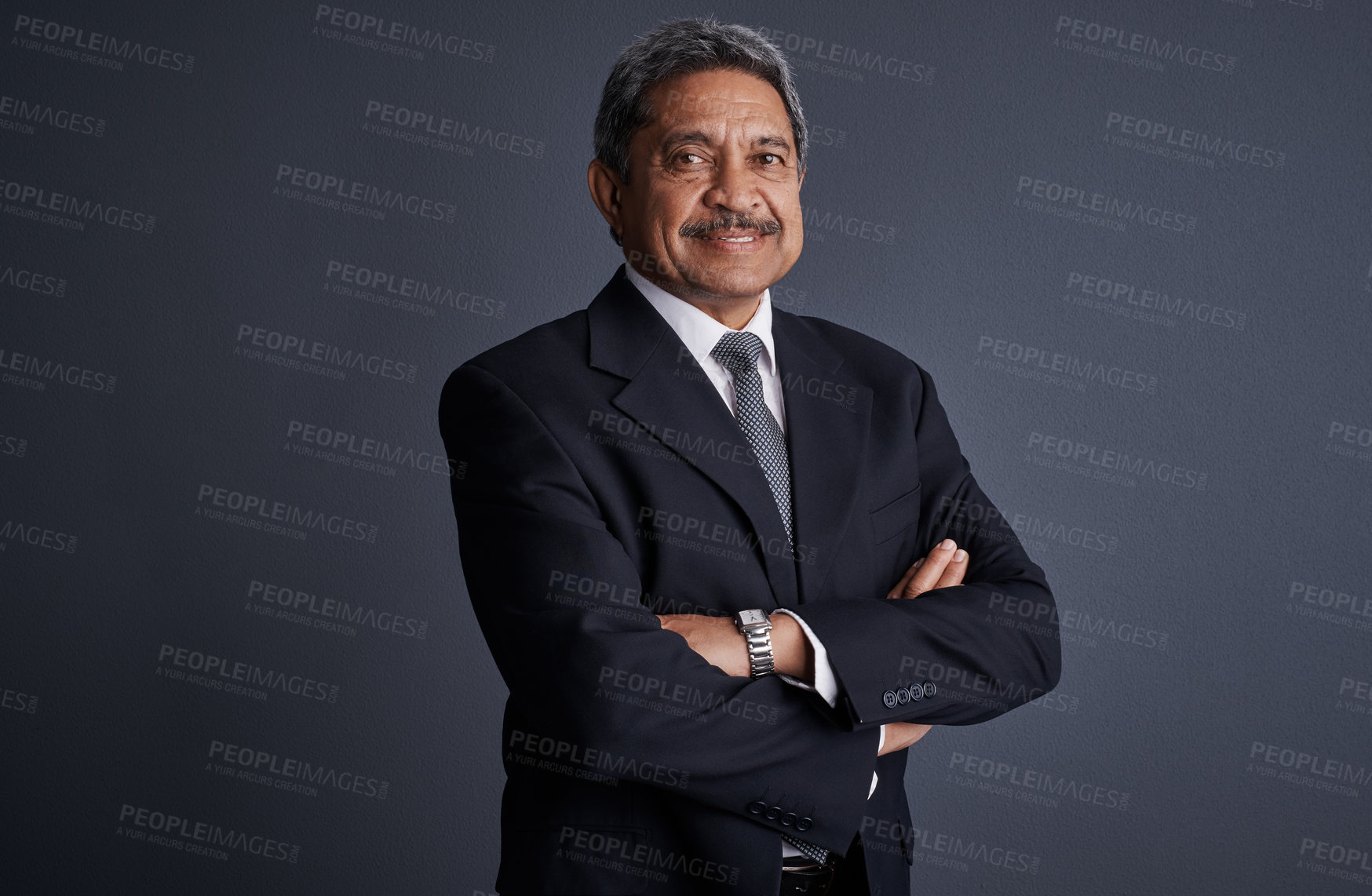 Buy stock photo Studio shot of a mature businessman posing against a dark background 