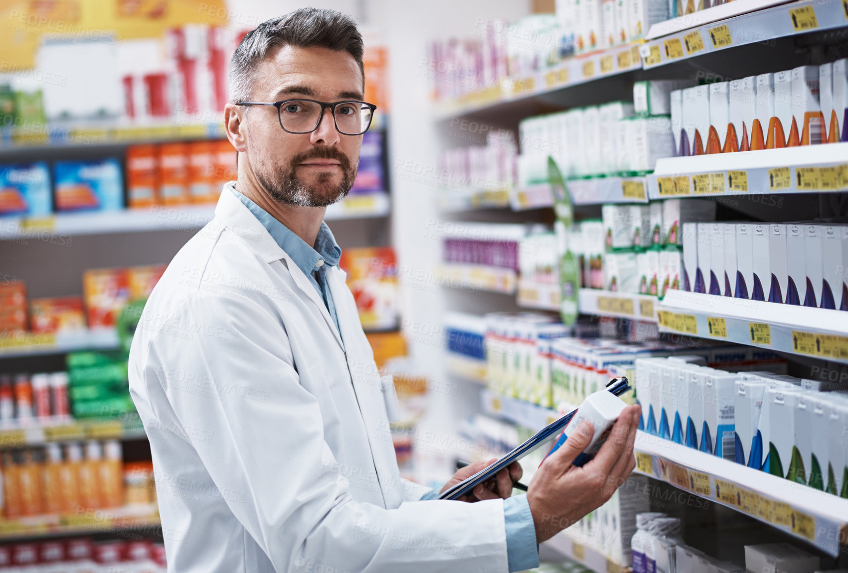 Buy stock photo Portrait of a mature pharmacist doing inventory in a pharmacy