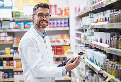 Buy stock photo Portrait of a mature pharmacist doing inventory in a pharmacy