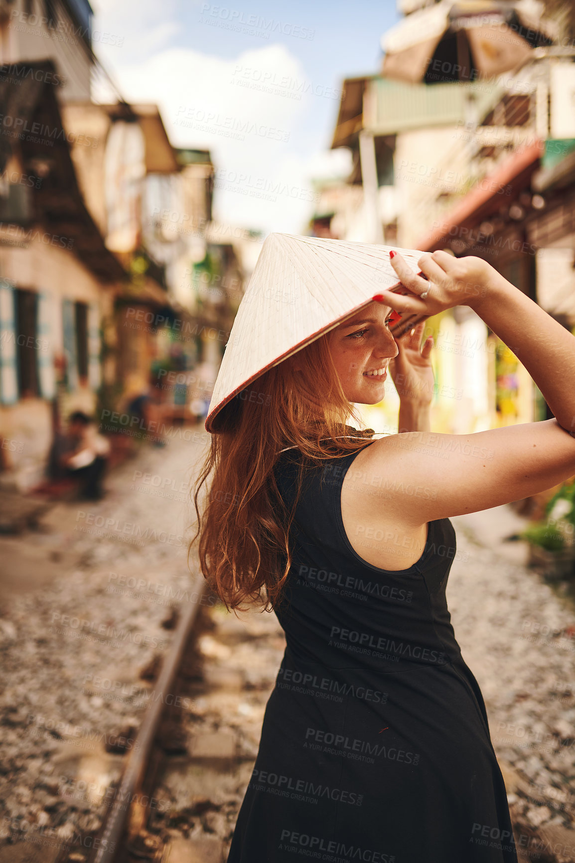 Buy stock photo Travel, happy and woman on train tracks in city for holiday, vacation and tourist destination in Vietnam. Fashion, sightseeing and person by railway for adventure, journey and explore urban town