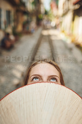 Buy stock photo Cropped shot of a woman holding a conical hat in front of her face