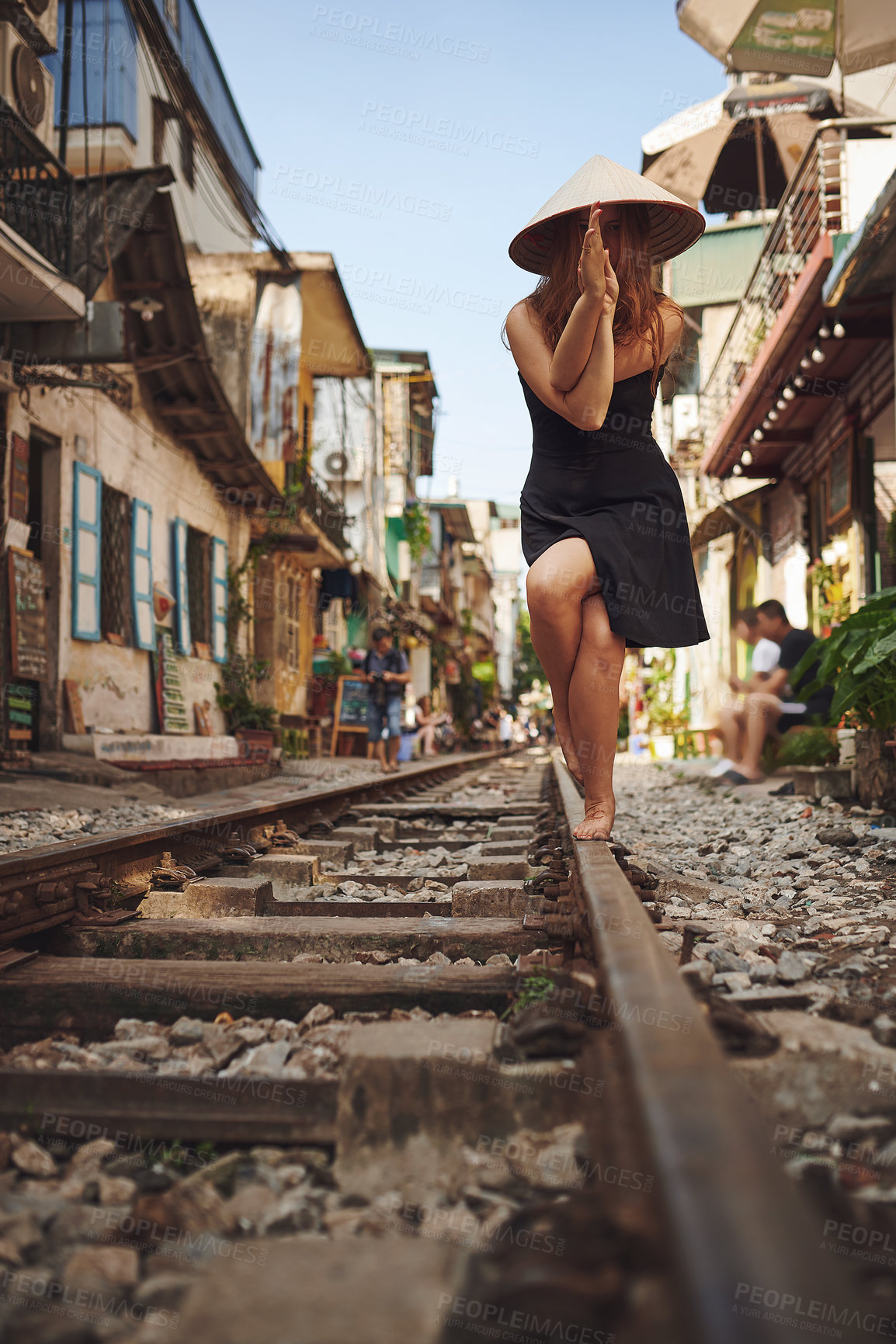 Buy stock photo Shot of a woman practising yoga while out on the streets of Vietnam