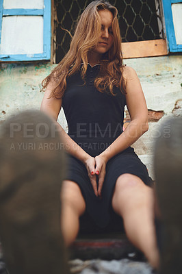 Buy stock photo Shot of a young woman sitting outside while exploring a foreign city