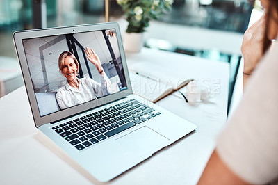 Buy stock photo Shot of a mature woman waving while appearing on a laptop screen during a video call