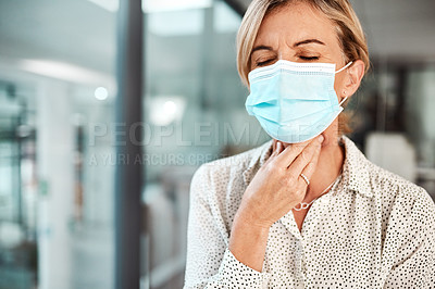 Buy stock photo Shot of a mature businesswoman wearing a mask and rubbing her throat in an office