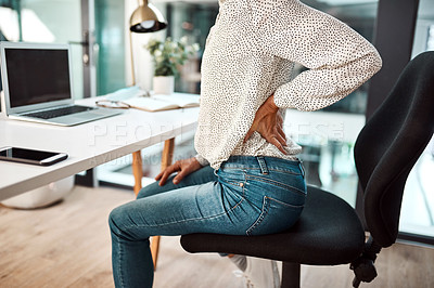 Buy stock photo Closeup shot of an unrecognisable businesswoman experiencing back pain while working in an office