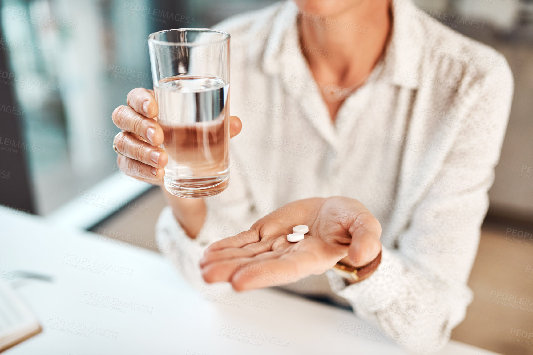 Buy stock photo Closeup shot of an unrecognisable businesswoman holding a glass of water and medication in an office