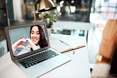 Buy stock photo Shot of a young woman making heart shape with her hands while appearing on a laptop screen during a video call