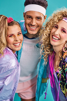 Buy stock photo Shot of three young people posing together in 80s clothing against a blue background