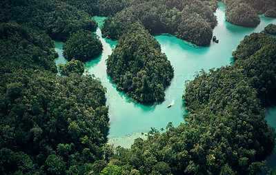 Buy stock photo High angle, boat and Indonesian island with ocean, water and tropical forest for travel or adventure. Sea, nature and ecology with landscape, scenery and environmental tourism for sailing holiday