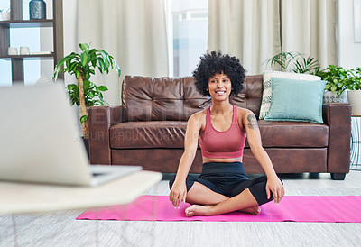 Buy stock photo Shot of a beautiful young woman looking at her laptop while practising yoga at home