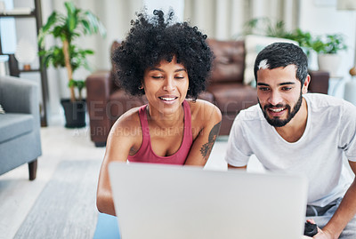Buy stock photo Shout of a young couple using a laptop while working out at home