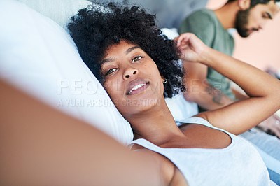 Buy stock photo Cropped shot of a woman taking a selfie while lying in bed with her boyfriend