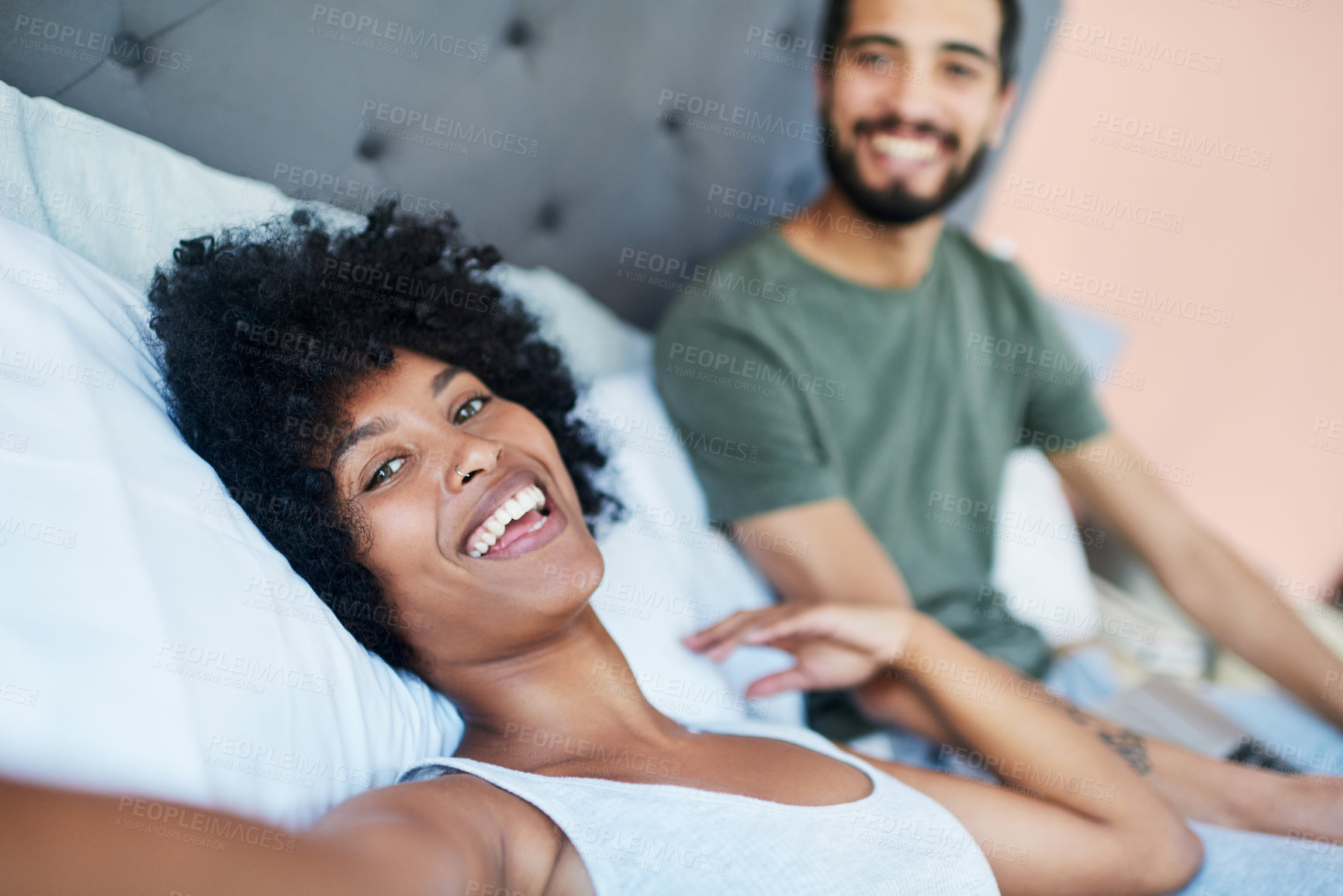 Buy stock photo Cropped shot of a woman taking a selfie while lying in bed with her boyfriend