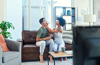Buy stock photo Shot of a woman trying to get her boyfriend's attention while he plays video games