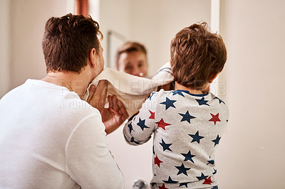 Buy stock photo Shot of a man and his young son drying their faces after shaving