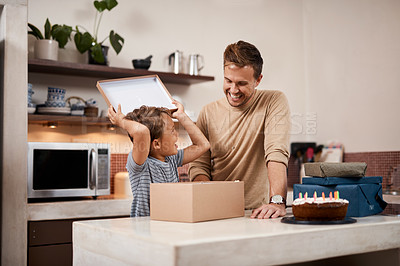 Buy stock photo Shot of a man surprising his son with cake and gifts on his birthday