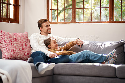 Buy stock photo Shot of a man and his son relaxing on the couch at home