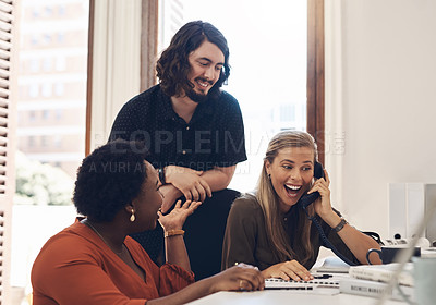 Buy stock photo Shot of a group of businesspeople looking excited while making a telephone call in an office