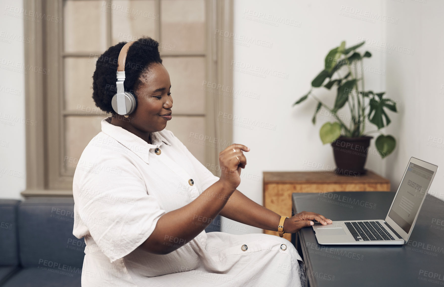 Buy stock photo Black woman, headphones and dancing by laptop in home office for job, break and listening to music. Happy, audio and freelancer with technology at table for remote work, streaming or article research