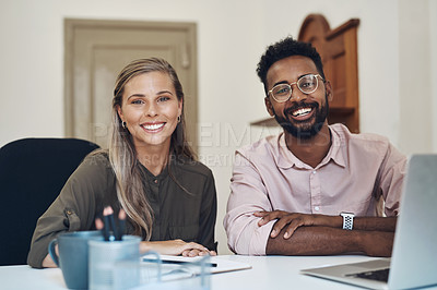 Buy stock photo Happy diverse employees working together on a project sitting in an office table satisfied with the partnership. Portrait of young colleagues with a positive mindset smiling about business growth