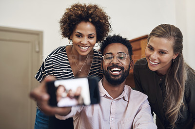 Buy stock photo Diverse, fun and happy business people taking a selfie on a phone in an office together. Smiling group of colleagues and friends bonding, laughing and enjoying their positive, healthy friendship
